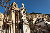 The cathedral of Cefal - The gates of the churchyard with the majestic Rocca in the background. 