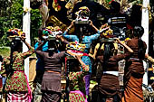 Cremation ceremony - Family members then passes ritual items up to be placed on the coffin. 