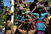 Cremation ceremony - Family members then passes ritual items up to be placed on the coffin. 