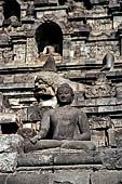 Borobudur - Buddha statues set in its own niche and pinnacles atop the balustrades of the lower four terraces.