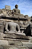 Borobudur - Buddha statues set in its own niche and pinnacles atop the balustrades of the lower four terraces.