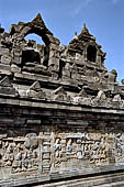 Borobudur - Buddha statues set in its own niche and pinnacles atop the balustrades of the lower four terraces.