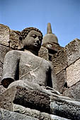 Borobudur - Buddha statues set in its own niche and pinnacles atop the balustrades of the lower four terraces.