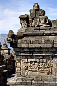 Borobudur - Buddha statues set in its own niche and pinnacles atop the balustrades of the lower four terraces.