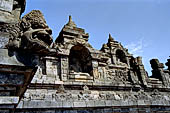 Borobudur - Water sprouts shaped like makaras are used on the lowest level, at the upper levels kala-like faces are used.