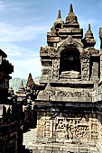 Borobudur - Buddha statues set in its own niche and pinnacles atop the balustrades of the lower four terraces.