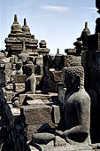 Borobudur - Buddha statues set in its own niche and pinnacles atop the balustrades of the lower four terraces.