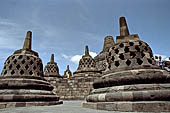 Borobudur - The 72 small stupa containing the Buddha statues on the upper three circular terraces around the central stupa.