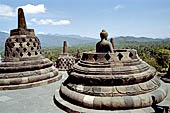 Borobudur - The 'invisible' Buddha placed inside  the bell shaped stupa of the upper terraces, two of them have been left exposed.