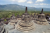 Borobudur - The 72 small stupa containing the Buddha statues on the upper three circular terraces around the central stupa.