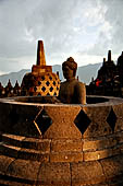 Borobudur - The 'invisible' Buddha placed inside  the bell shaped stupa of the upper terraces, two of them have been left exposed.