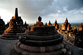 Borobudur - The 'invisible' Buddha placed inside  the bell shaped stupa of the upper terraces, two of them have been left exposed.