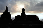 Borobudur - Buddha image of the upper terrace at dusk. Night was an auspicious time for the meditation.