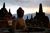 Borobudur - The 'invisible' Buddha placed inside  the bell shaped stupa of the upper terraces, two of them have been left exposed.