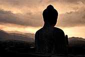 Borobudur - Buddha image of the upper terrace at dusk. Night was an auspicious time for the meditation.