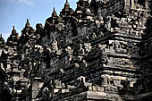 Borobudur - Buddha statues set in its own niche and pinnacles atop the balustrades of the lower four terraces.