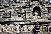 Borobudur - The outer wall of the first balustrade decorated with reliefs of celestial beings and guardian demons.