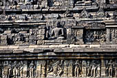 Borobudur - The outer wall of the first balustrade decorated with reliefs of celestial beings and guardian demons. 