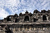 Borobudur - The outer wall of the first balustrade decorated with reliefs of celestial beings and guardian demons.