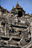 Borobudur - Buddha statues set in its own niche and pinnacles atop the balustrades of the lower four terraces.