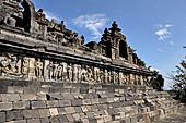 Borobudur - The outer wall of the first balustrade decorated with reliefs of celestial beings and guardian demons.