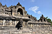 Borobudur - The outer wall of the first balustrade decorated with reliefs of celestial beings and guardian demons.