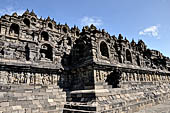 Borobudur - The outer wall of the first balustrade decorated with reliefs of celestial beings and guardian demons.