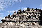 Borobudur - The outer wall of the first balustrade decorated with reliefs of celestial beings and guardian demons.