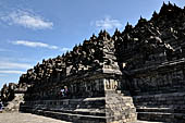 Borobudur - The outer wall of the first balustrade decorated with reliefs of celestial beings and guardian demons.