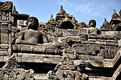 Borobudur - Buddha statues set in its own niche and pinnacles atop the balustrades of the lower four terraces.