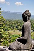 Borobudur - Buddha statues on the balustrades of the lower levels.