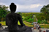 Borobudur - Buddha statues on the balustrades of the lower levels. 