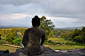 Borobudur - Buddha statues on the balustrades of the lower levels. 