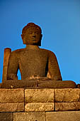 Borobudur - Buddha statues on the balustrades of the lower levels. 