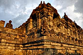 Borobudur - Buddha statues set in its own niche and pinnacles atop the balustrades of the lower four terraces. 