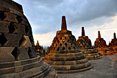 Borobudur - The 72 small stupa containing the Buddha statues on the upper three circular terraces around the central stupa. 