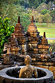 Borobudur - The 'invisible' Buddha placed inside  the bell shaped stupa of the upper terraces, two of them have been left exposed. 