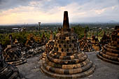 Borobudur - The 72 small stupa containing the Buddha statues on the upper three circular terraces around the central stupa. 