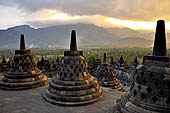 Borobudur - The 72 small stupa containing the Buddha statues on the upper three circular terraces around the central stupa. 