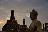 Borobudur - The 'invisible' Buddha placed inside  the bell shaped stupa of the upper terraces, two of them have been left exposed. 