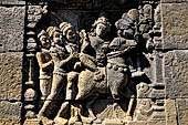 Borobudur reliefs of the First Gallery balustrade - Panel 29. Scene from the Jatakamala, the future Buddha is attacked by ogres. 