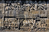 Borobudur reliefs - First Gallery, Northern side - Lalitavistara. Panel 83. God gives Sakiamuni a reddish robe. 