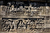 Borobudur reliefs - First Gallery, Northern side - Lalitavistara. Panel 105. Merchants give honey and cream to Buddha. 