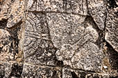 Chichen Itza - Great Ball court. Detail of the bas-reliefs on the side benches.