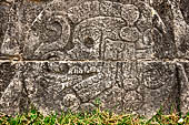 Chichen Itza - Great Ball court. Detail of the bas-reliefs on the side benches. A skull inside the ball marks the canter of the panel.