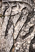 Chichen Itza - Great Ball court. Detail of the bas-reliefs on the side benches. Spurts of blood of the defeated warrior shown in the form of six serpents gush from his severed neck.