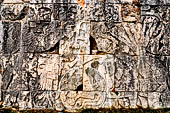 Chichen Itza - Great Ball court. Detail from the east panel.   a figure at left holding a severed head, in the centre a ball decorated with a human skull. To the right spurts of blood shown in the form of six serpents gush from a decapitated player.