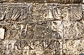 Chichen Itza - Great Ball court. Detail of the bas-reliefs on the side benches. This detail shows at left a decapitated figure with spurts of blood shown in the form of six serpents, in the centre there is the ball decorated with a human skull. 