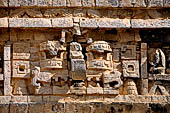 Chichen Itza - The Monjas (Nunnery) palace complex. La Iglesia (the church),  'big nosed' mask of Chac God. A seated figure, god or ancestor, is integrated upon the nose of the central mask. 