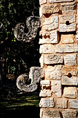 Chichen Itza - El Osario pyramid (the Ossuary). Part of the decoration of the top of the structure consisted of stacked masks in Puuc style. They may represent rain gods (Chac).